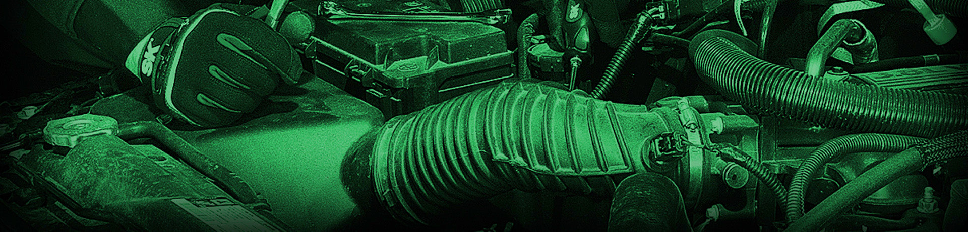 Close-up of a mechanical engine with green lighting